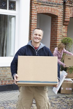 Man with van loading household items for transport