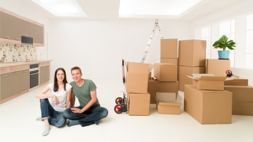 Family home move preparation with labelled boxes and wrapped furniture